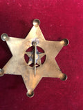 Badge: Solid brass Deputy U.S. Marshal with cut out star.