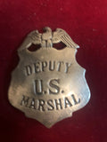 Badge: Sterling plated eagle over shield Deputy U. S. Marshal